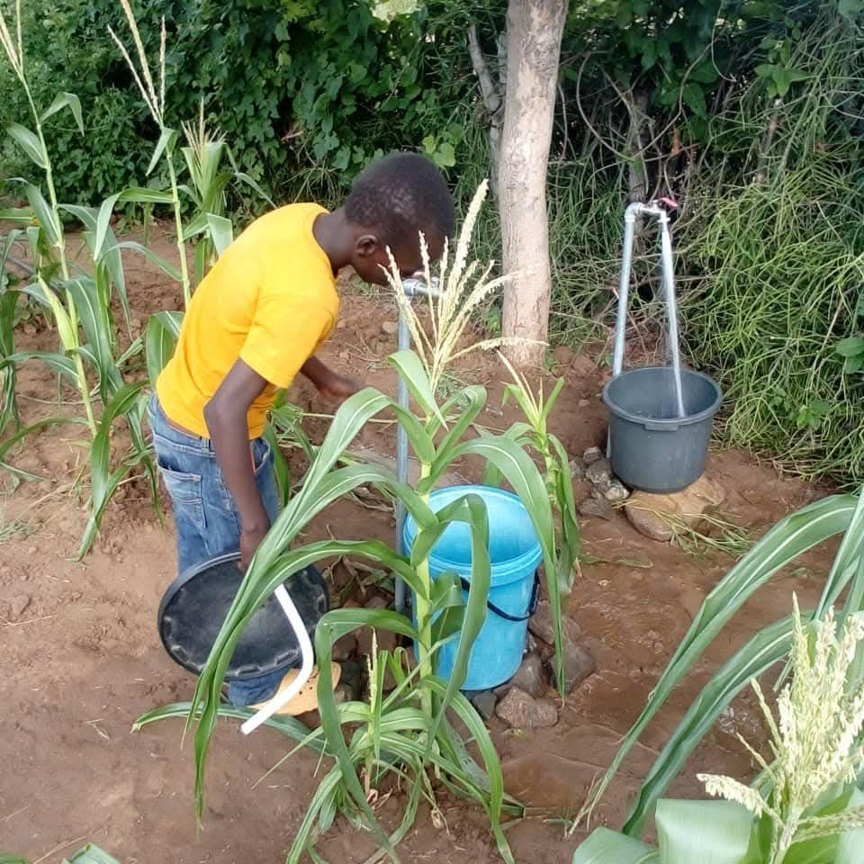 Boy Collecting Clean Water