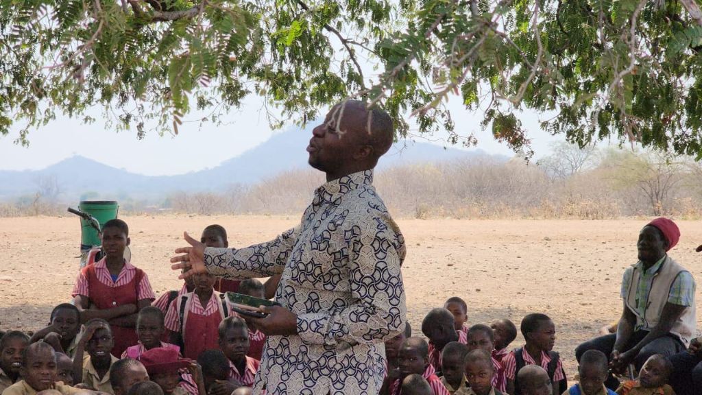 Speaker engaging students at the outdoor ceremony